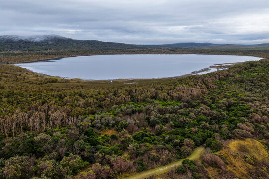 Aerial view of Lake Arragan and the surrounding natural landscape within Yuraygir National Park, showcasing the coastal lake, native bushland, wetlands and expansive wilderness 