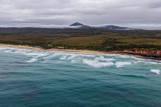 Aerial view of Red Cliff Campground and the surrounding coastal landscape within Yuraygir National Park, featuring campsites surrounded by native bushland near the Pacific coastline on the NSW 