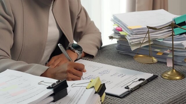 Legal Professional Signing Official Documents in Law Office