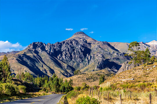 A view down a road towards the rugged side of the Colca Valley area of the Andes in southern Peru in the dry season