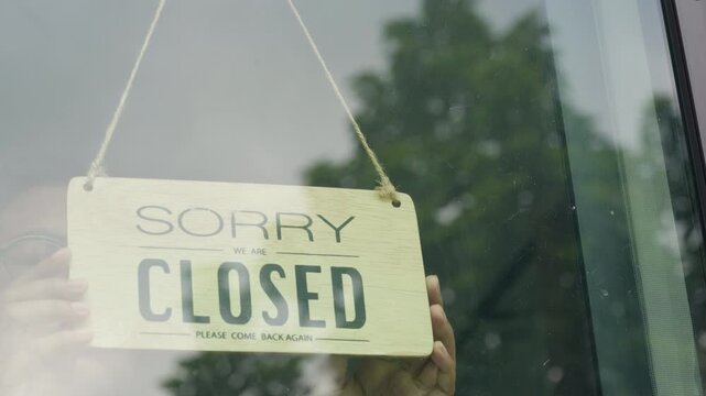 Welcome Open Sign Hanging on Glass Door at Business Entrance