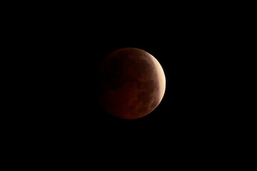 Blood Moon during a lunar eclipse in dark night sky © Juanma