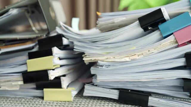 Large Piles of Business Documents and Paperwork on Office Desk