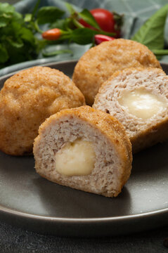 Fried Meat Cutlets Stuffed with Melted Cheese on Dark Plate