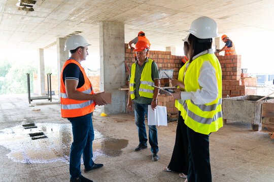 Workers and managers evaluate quality of building materials. Inspectors take into account characteristics of brick to form verification report