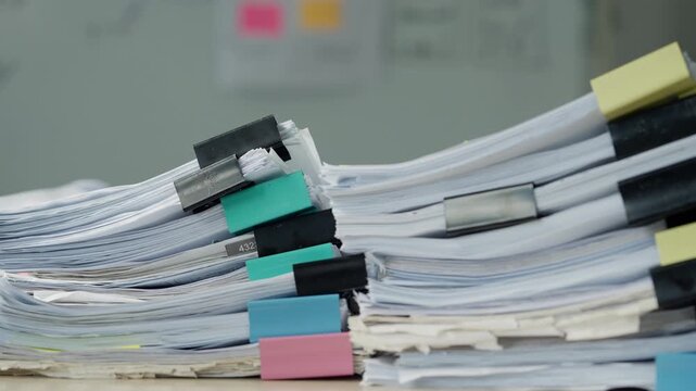 Large Stacks of Business Documents and Paperwork on Office Desk