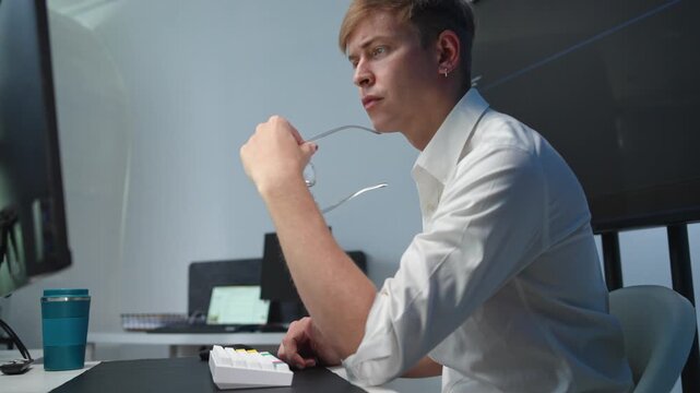 Dedicated young professional reviewing data and jotting down insights in a contemporary office environment