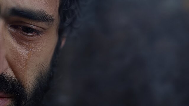 Close-up of crying man with tear on cheek. Biblical scene of Peter weeping after betrayal of Jesus. Repentance, sorrow and forgiveness concept. Holy week and Easter story.