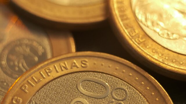 Extreme close-up of a Philippine twenty peso coin beside another coin portrait.