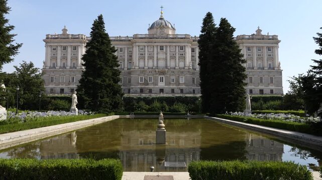 Historic Royal Palace Of Madrid Reflected In The Reflecting Pool Of Sabatini Gardens In Spain. wide shot