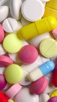 Colorful Pills and Capsules Slowly Rotating. Macro view of assorted tablets and capsules rotating smoothly.