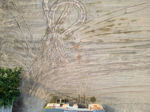 Aerial Drone View of Complex Tractor Tire Track Patterns on Sandy Agricultural Field in Rijkevorsel, Belgium
