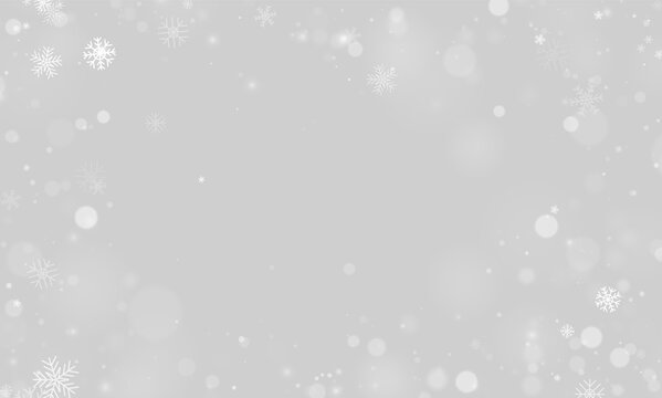 Delicate white snowflakes scattered against a black background with soft blurred bokeh lights on transparent background
