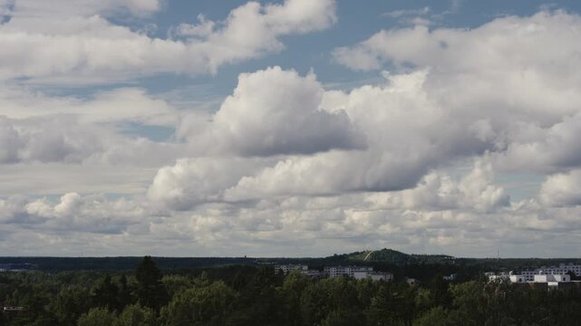 Atmospheric time-lapse of clouds moving across the sky above Helsinki city, Finland, showing the urban skyline and changing weather conditions.