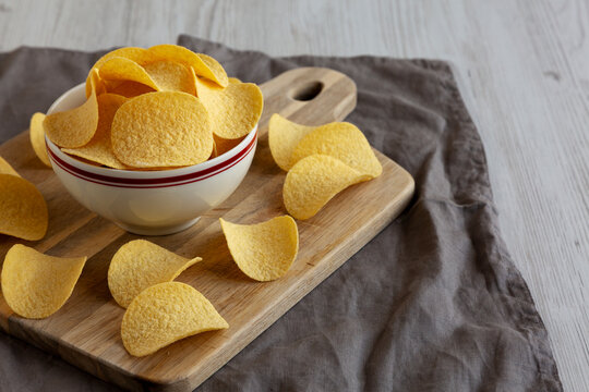 Crispy Cheese and Onion Flavoured Potato Chips in a Bowl, side view.