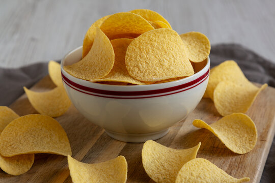 Crispy Cheese and Onion Flavoured Potato Chips in a Bowl, side view.