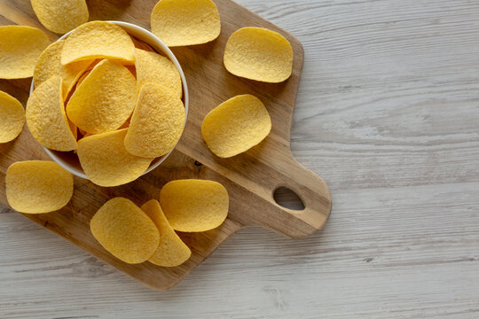 Crispy Cheese and Onion Flavoured Potato Chips in a Bowl, top view. Copy space.