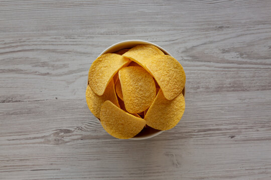 Crispy Cheese and Onion Flavoured Potato Chips in a Bowl, top view.