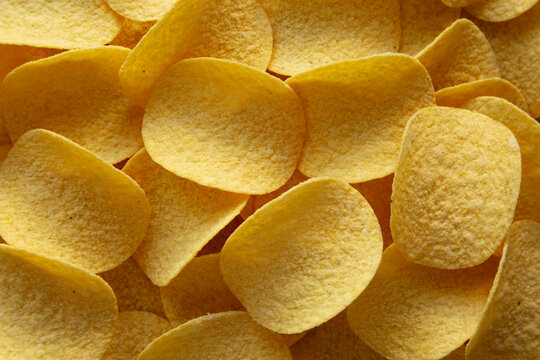 Crispy Cheese and Onion Flavoured Potato Chips in a Bowl, top view.