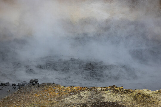 View of the bubbling mud pots and steam vents at Seltun Geothermal Area with volcanic soil and rocky terrain in Grindavik, Hafnarfjardarkaupstadur, Iceland.