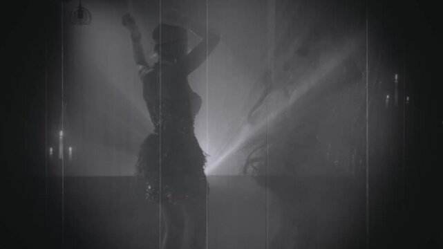 old film 1920s style black and white color, dark silhouette two happy active woman dancing in night club. Sexy joy girls flapper female have fun at dance floor retro party new year roaring twenties