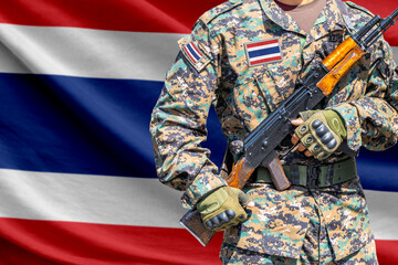 Naklejka premium Thailand flag with soldier holding assault rifle