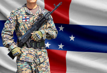 Naklejka premium Netherlands Antilles flag with soldier holding assault rifle