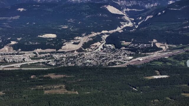 panning left across Golden, a town in southeastern British Columbia, Canada, nestled in the Rocky Mountain Trench 4k aerial video footage 