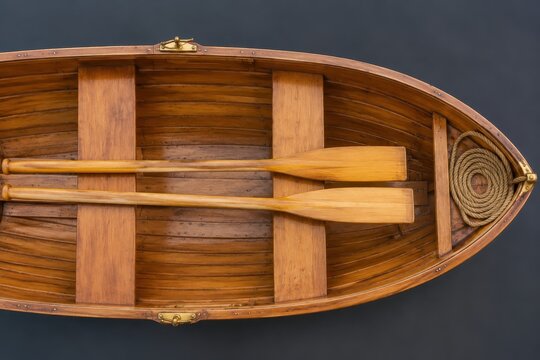 Wooden oars and rowlocks resting across a clinker boat