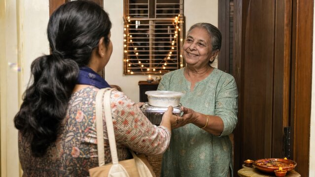 A community volunteer delivering a festive meal to an older neighbor living alone, overhead editorial flat lay, for commercial stock use