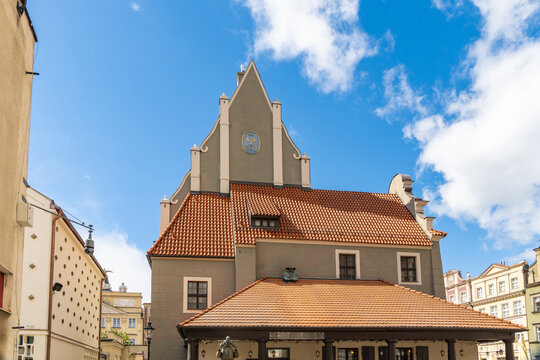 View of the historic Weigh House with its distinctive stepped gable and orange tiled roof in the Old Market Square of Poznan, Greater Poland Voivod, Poland.
