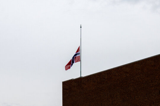 Norwegian flag flying half-mast over a building in Oslo