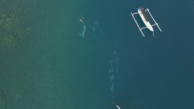 People Scuba Diving In The Blue Water Of Jemeluk Bay Amed Beach Bali Indonesia Birdseye 4K 60FPS