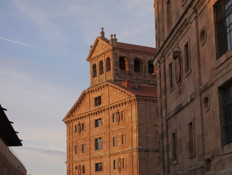 View of the historic sandstone architecture of the Pontifical University of Salamanca with ornate carvings and arched windows in Salamanca, Castile and Leon, Spain.