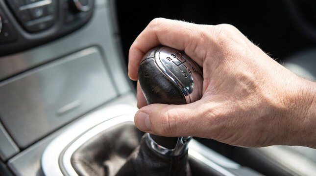 Driver hand on gearshift in a car interior  