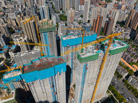 Aerial view showing construction cranes working on large residential apartment towers in the growing urban city of Wuhan China