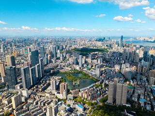Fototapeta premium A wide aerial view of the modern urban skyline and city buildings located in Wuhan China showing the dense architecture and urban landscape on a clear day