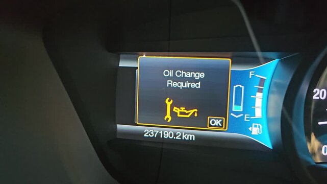 Dashboard of a vehicle displaying an oil change required notification with maintenance icon illuminated, emphasizing the need for timely vehicle service to ensure optimal performance and safety. 4k