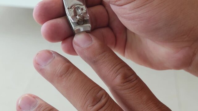 Male grooming nail clipping cutting up-close personal care hygiene