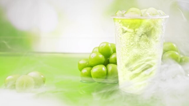 Fresh Green Grape Shine Muscat Slushie Smoothie Cold Drink In Dry Ice Smoke Mist Fog Green Bokeh Background Summer Fruit Commercial Video