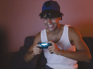 Young man engrossed in playing video games. © Maksic Images