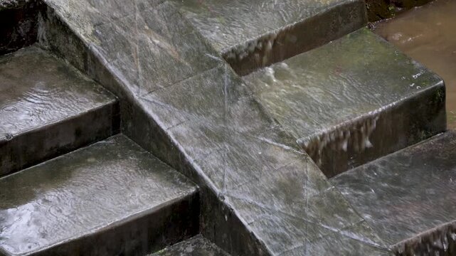 Rain water flowing down the concrete steps