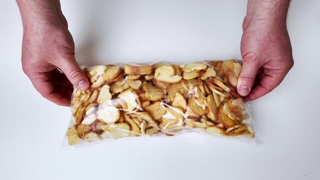 Assortment of mixed nuts and dried fruit laid out on a clean white surface, perfect for healthy snacking or baking ingredients, vibrant natural colors