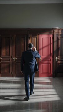 Doubtful man in front of many different doors choosing one. Difficult decision, concept of important choice in life, failure or success. Ways to unknown future career development