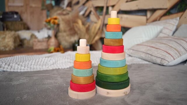 Wooden stacking rings toy on floor, educational game for children, natural wood, minimalist design, playful decoration.