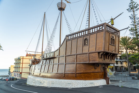 View of the Santa Maria ship replica monument featuring a wooden hull and masts situated on a street corner near the coast in Santa Cruz de La Palma, Canary Islands, Spain.