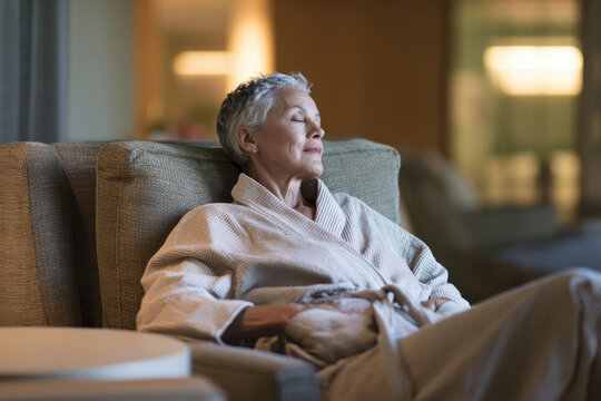 A relaxed woman enjoys a serene moment in her chair, absorbing the peaceful ambiance of her surroundings, highlighting the beauty of comfort and tranquility.