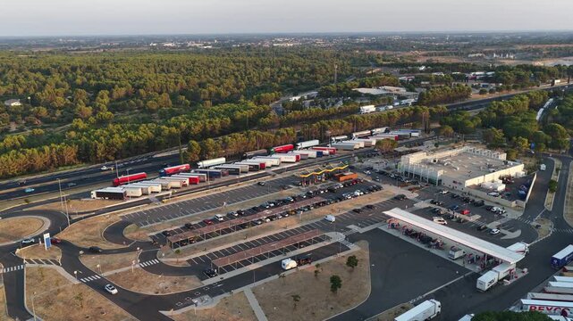 Villetelle, France - July 25, 2026: aerial view of the Fastned charging station at A9 Aire d'Ambrussum Nord service area with parking area and motorway infrastructure