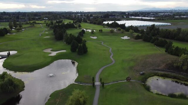 Drone aerial over golf course with Canadian shaped maple leaf and heart bunker