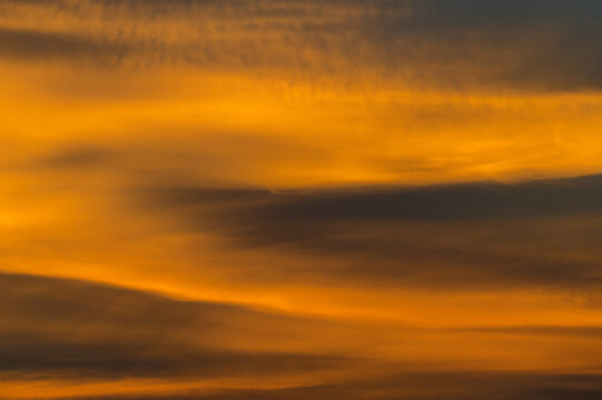 View of vibrant orange sunset clouds in Jahanian, Punjab, Pakistan.